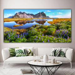 Tablou canvas peisaj colorat montan langa lac cu pajiste cu flori mov